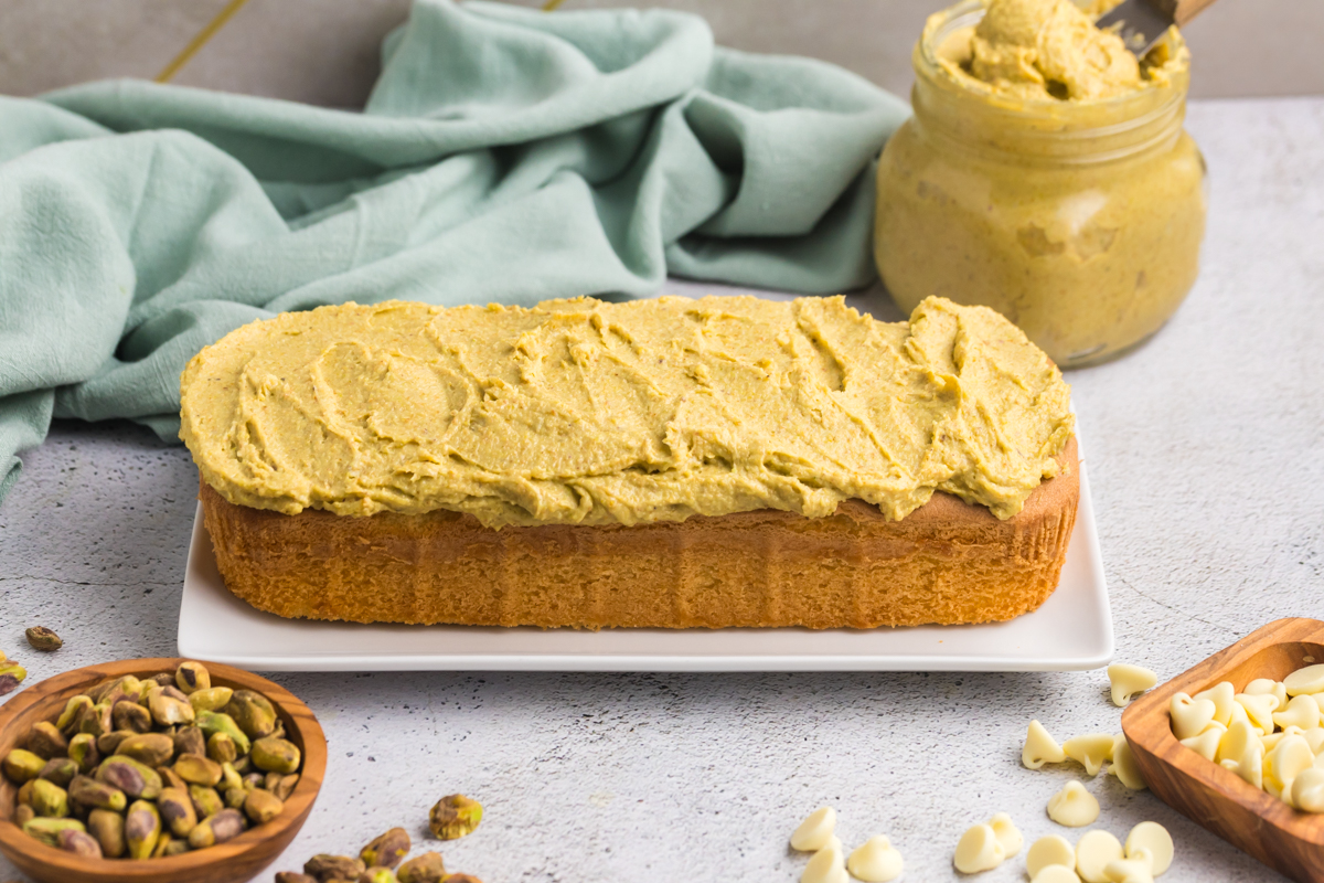 pound cake on plate topped with pistachio cream